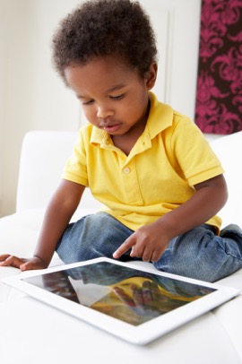Child pointing to a tablet